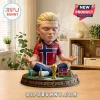 Erling Haaland bobblehead figure in Norway jersey meditating on a 2026 World Cup base with landmarks and trophy.!