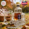 Crown Royal whiskey glass decanter shaped like an excavator with a metal cap and label on a grassy field by a picnic basket.!