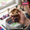 Vinyl FC Barcelona player figurine in a blue and red kit held in hand over a miniature Camp Nou stadium model.!