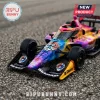 IndyCar race car model with Grateful Dead tie-dye pattern, number 610, SiriusXM, and Clopay logos on gravel surface.!