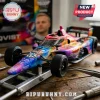 Die-cast IndyCar model with tie-dye Grateful Dead livery and Firestone tires on a metal assembly jig.!