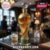 FIFA World Cup 2026 trophy shaped glass whiskey decanter with soccer ball stopper on a dark marble bar counter.!