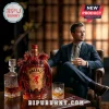 Fireball Cinnamon Whisky bottle featuring sculpted red dragon details next to a man in a suit holding a whiskey glass.!
