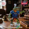 Faceted crystal alligator decanter with blue jersey, marked 1906-2026 120th anniversary, resting on a leather desk surface.!