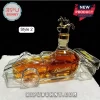 Blanton's bourbon whiskey decanter shaped like a race car with a gold horse stopper, sitting on a white surface.!
