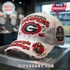 Georgia Bulldogs white distressed cap with Super Regional Champions text, NCAA College World Series patch, and trophy pin.!