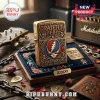 Grateful Dead brass Zippo lighter with Steal Your Face logo in a navy velvet presentation box on a wooden desk.!