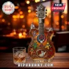 Grateful Dead 60th anniversary guitar-shaped whiskey bottle with colorful dancing bears and rose logos on wooden bar top.!