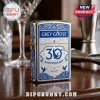 Chrome lighter featuring blue and silver Grey Goose 30th anniversary branding with scrollwork on a wooden bar surface.!