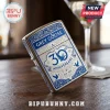 Grey Goose 30th anniversary metal lighter in silver and blue with ornate filigree and branding on a wooden table.!