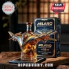 Milano spaceship shaped glass whiskey bottle with gold and blue details, sitting on a black base next to branded box.!