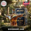 Milano spaceship-shaped glass whiskey bottle with amber liquid and matching blue and gold box on a stone pedestal.!