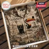 Guinness branded beige Hawaiian-style shirt with toucan, pint glass, and St. James's Gate prints in a cardboard gift box.!