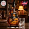 Glass guitar-shaped whiskey bottle featuring a Slash graphic, Jim Beam branding, and Rock N Roll Legend text on a wood desk.!