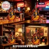 Electric guitar shaped glass whiskey bottle with Slash graphic, amber liquid, and black screw cap on wooden bar surface.!