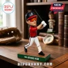 Ha-Seong Kim baseball bobblehead wearing red jersey, white pants, and orange visor on a green-bordered base.!