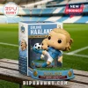 Erling Haaland vinyl collectible figurine kicking a soccer ball, mounted on a base with text, in front of product box.!