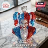 Harley Quinn faceted crystal glass bust decanter with red and blue hair and a heart-shaped topper on a marble table.!
