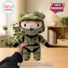 Hello Kitty plush wearing green Spartan Master Chief armor with a gold visor, held against a room background.!