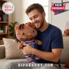 Brown plush cat toy with dreadlocks wearing a blue New York basketball jersey and orange sneakers held by a man.!