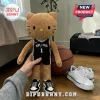 Brown Hello Kitty plush wearing a black San Antonio Spurs number 1 basketball jersey and miniature black and white sneakers.!