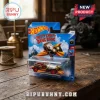 Hot Wheels Chitty Chitty Bang Bang die-cast vehicle in blue blister packaging on a rustic wooden table.!