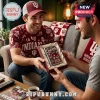 Man gifting a boxed Indiana Hoosiers Zippo lighter with vintage mascot graphic to a friend in a living room.!