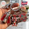 Metal keychain featuring a Borg-Warner Trophy replica, a red IndyCar, and an Indianapolis 500 110th anniversary medallion.!