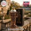 Indy 500 trophy style whiskey decanter with silver racing driver topper and checkered flag on stone railing background.!