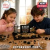 Children building an Indy 500 trophy and racing car brick set on a wooden table with visible text reading Indy 500 2026.!