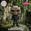 Eddie from Iron Maiden vinyl figure with red eyes, horns, and leather jacket standing on a mossy stone wall.!