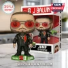 J Balvin Funko Pop figure wearing red-tinted sunglasses, black leather jacket, and lightning bolt design on green stand.!