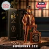 Amber glass Jack Daniel's 160th anniversary figurine bottle wearing a hat, standing next to a square safe display box.!