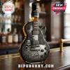 Guitar-shaped Jack Daniel's Tennessee Whiskey bottle with skull, rose, and Slash signature motifs on a bar counter.!