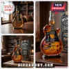 This sunburst guitar shaped bottle with Slash graphic and signature with Tennessee Whiskey text on a wood table!
