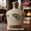 Jacksonville Jaguars 31st anniversary commemorative ceramic liquor bottle with crown topper on a wooden table.!