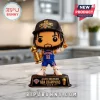Jalen Brunson vinyl figure wearing a New York Knicks jersey and NBA Champions 2026 cap holding a gold trophy on a base.!