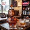 Jalen Brunson bust-shaped glass whiskey decanter with orange and blue jersey, basketball topper, on wooden desk background.!