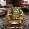 Gold ring featuring a Jeep icon, green stone inlay, and 85th anniversary text on a wooden surface.!