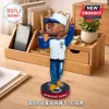 Jermaine Dupri bobblehead figure wearing a white and blue varsity jacket, blue jeans, and cap on a circular branded base.!