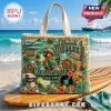 Jimmy Buffett Margarittaville tote bag featuring 3D parrot, guitar, sailboat, and nautical charms on a beach background.!