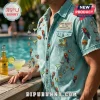 Light blue denim short-sleeve shirt with embroidered tropical patches including parrots, margaritas, burgers, and palm trees.!