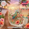Stemless glass featuring a macaw, hibiscus flowers, and the text It’s Five O’Clock Somewhere against a tropical sunset.!