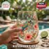 Stemless wine glass featuring a hand-painted macaw parrot, hibiscus flowers, gold rim, and hanging crystal accents.!