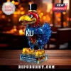 Kansas Jayhawks mascot glass decanter wearing a top hat with KU logo and 2026 Big 12 Champions base on a wooden table.!