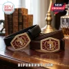 Kappa Alpha Psi fraternity belts with gold metal buckles, red enamel shields, and leather straps on a wooden table.!