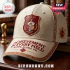 Off-white faux leather baseball cap featuring Kappa Alpha Psi embroidery, fraternity crest, and motto on a wooden desk.!