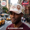 White Kappa Alpha Psi baseball cap with gold embroidery, 1911 text, diamond emblem, and crimson accents on a man in a city.!