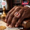Kappa Alpha Psi fraternity ring with large red center stone and diamond accents worn on a hand over a vintage book.!