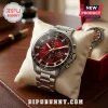 Kappa Alpha Psi silver chronograph watch with red dial, diamond hour markers, and stainless steel link band on a pillow.!